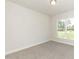 A bedroom features neutral walls, carpet flooring, recessed lighting, and a bright window at 587 Glenkirk Pl, Garner, NC 27529