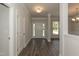 Inviting foyer with light gray walls and contrasting white doors and trim at 587 Glenkirk Pl, Garner, NC 27529