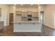 Kitchen boasts gray cabinets, granite countertops, stainless steel appliances, and island with sink at 587 Glenkirk Pl, Garner, NC 27529