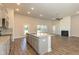 Kitchen with stainless appliances, granite countertops, an island and open to the living area with fireplace at 587 Glenkirk Pl, Garner, NC 27529