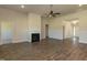 Bright living room features a fireplace, ceiling fan, and neutral decor at 587 Glenkirk Pl, Garner, NC 27529