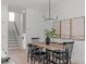 Bright dining room features a wooden table, black chairs, modern lighting, and artwork at 612 Rocky Knob Ct, Raleigh, NC 27601