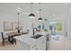 Modern kitchen with white cabinets, quartz countertops, an island, and open layout to living area at 612 Rocky Knob Ct, Raleigh, NC 27601