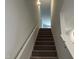 Modern staircase with carpeted steps and a simple handrail at 6856 Galloway Dr, Middlesex, NC 27557