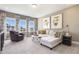 Bright living room with large windows, neutral tones, and stylish decor provides an inviting space at 909 Jasper Mine Trl, Raleigh, NC 27610