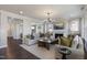An open-concept living room with a fireplace and seamless flow to the dining and kitchen areas at 909 Jasper Mine Trl, Raleigh, NC 27610