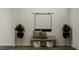 Inviting entryway featuring a modern bench, accent pillows, decorative plants, and stylish baskets for added storage at 913 Jasper Mine Trl, Raleigh, NC 27610