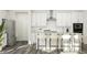 Bright kitchen features white cabinets, stainless appliances, quartz counters, subway tile backsplash, and counter seating at 913 Jasper Mine Trl, Raleigh, NC 27610