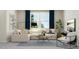 Bright living room featuring a comfortable sectional sofa, stylish coffee table, and large windows with blue curtains at 913 Jasper Mine Trl, Raleigh, NC 27610