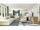 Open-concept living room featuring a sectional sofa, accent chairs, modern tables, and stylish decor at 913 Jasper Mine Trl, Raleigh, NC 27610
