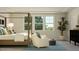 Serene main bedroom featuring a cozy bed, comfortable chairs, and large windows with natural light at 913 Jasper Mine Trl, Raleigh, NC 27610