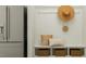 Mudroom with bench, storage, white board and batten walls, hat, pillows and stainless steel refrigerator at 913 Jasper Mine Trl, Raleigh, NC 27610