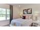 This stylish bedroom features calming decor and natural light at 921 Jasper Mine Trl, Raleigh, NC 27610