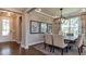 Dining room with modern chandelier, art, and natural light at 921 Jasper Mine Trl, Raleigh, NC 27610