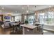 Kitchen island with sink and seating open to living and dining rooms at 921 Jasper Mine Trl, Raleigh, NC 27610