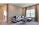 Stylish living room with comfortable seating, modern decor, and an abundance of natural light at 921 Jasper Mine Trl, Raleigh, NC 27610