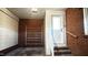 Mud room with brick walls, storage shelves and tiled stairs at 1208 Park Ave, Garner, NC 27529