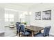 Bright dining area with modern chandelier, adjacent to the living room, and featuring views to the outdoors at 1319 Hollyview Ave, Durham, NC 27703