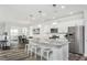 Bright and open kitchen with a large island, stainless steel appliances, and views into the dining and living areas at 1319 Hollyview Ave, Durham, NC 27703