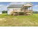 Home's backyard showing a large deck and screened in porch and spacious yard at 243 Kissington Way, Benson, NC 27504