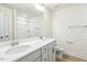 Modern bathroom with double vanity, large mirror, and tile flooring at 243 Kissington Way, Benson, NC 27504