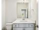 Modern bathroom features grey vanity, quartz countertop and a large mirror at 243 Kissington Way, Benson, NC 27504