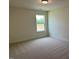 A cozy bedroom offers carpet floors and a window with lots of natural light at 243 Kissington Way, Benson, NC 27504