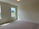 Well-lit bedroom with neutral carpet, large window, and a comfortable feel at 243 Kissington Way, Benson, NC 27504