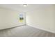 Bedroom features neutral tones, plush carpet, and great outdoor views at 243 Kissington Way, Benson, NC 27504