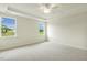 Spacious bedroom with two windows and tray ceiling, providing ample natural light at 243 Kissington Way, Benson, NC 27504