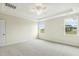 Bright, carpeted bedroom with tray ceiling and dual windows offering outdoor views at 243 Kissington Way, Benson, NC 27504