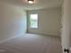 Bedroom featuring soft carpet, a window, and a neutral color scheme at 243 Kissington Way, Benson, NC 27504