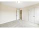 Bedroom featuring plush carpet and a closet with bi-fold doors for ample storage at 243 Kissington Way, Benson, NC 27504