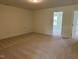 Carpeted bonus room featuring a doorway leading to another room in the house at 243 Kissington Way, Benson, NC 27504