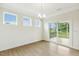 Bright dining area with wood floors, chandelier and sliding glass doors to deck at 243 Kissington Way, Benson, NC 27504