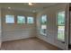 Dining room with hardwood floors, lots of light from the large windows and white trim at 243 Kissington Way, Benson, NC 27504