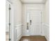 Bright foyer with white walls and trim and hardwood floors at 243 Kissington Way, Benson, NC 27504