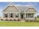 Charming single-story home with stone accents, manicured lawn, and inviting front porch at 243 Kissington Way, Benson, NC 27504