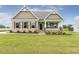 Inviting single-story home with a well-maintained lawn and a welcoming front porch at 243 Kissington Way, Benson, NC 27504