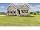 Attractive single-story home with stone accents, well-kept lawn, and inviting front porch at 243 Kissington Way, Benson, NC 27504