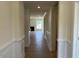 Hallway with wood-look flooring leading to the living area with lots of natural light at 243 Kissington Way, Benson, NC 27504