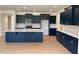 Kitchen features dark cabinets, stainless steel appliances, and a large island with a white countertop at 243 Kissington Way, Benson, NC 27504