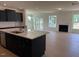 Open-concept kitchen with stainless steel appliances and view of the living area at 243 Kissington Way, Benson, NC 27504