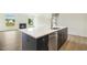 Kitchen island with stainless steel appliances and fireplace in the living room at 243 Kissington Way, Benson, NC 27504