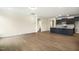 Open concept kitchen features black cabinets, stainless appliances, granite countertops and wood flooring at 243 Kissington Way, Benson, NC 27504
