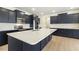 Modern kitchen with a quartz countertop island, stainless steel appliances, and ample cabinet space at 243 Kissington Way, Benson, NC 27504