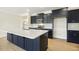 Modern kitchen featuring a quartz countertop island and stainless steel appliances with ample cabinet space at 243 Kissington Way, Benson, NC 27504