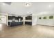 Open kitchen features black cabinets, stainless appliances, granite countertops and wood flooring at 243 Kissington Way, Benson, NC 27504