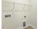 Bright laundry room featuring hookups, electrical outlet, and a wire shelf for storage at 243 Kissington Way, Benson, NC 27504
