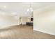 Bright living room featuring wood floors and an open kitchen with black cabinets and granite countertops at 243 Kissington Way, Benson, NC 27504